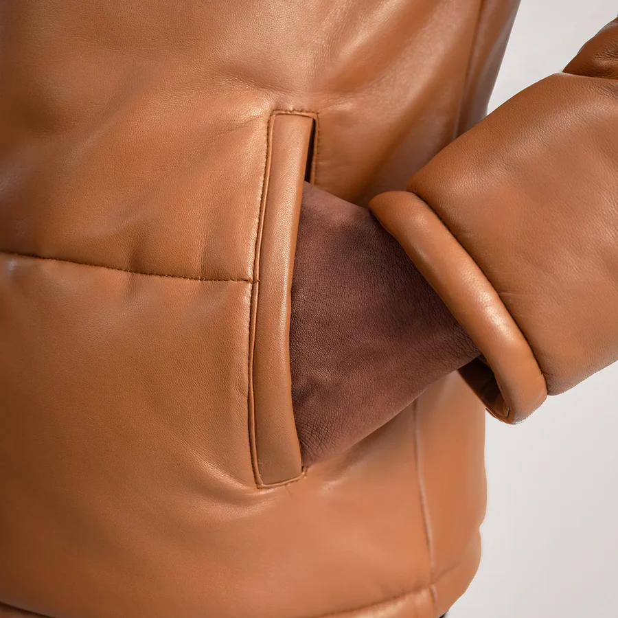 Hero shot of premium jacket showcasing leather texture in natural light